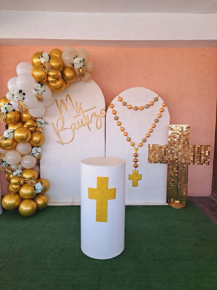 a table topped with balloons and a cross