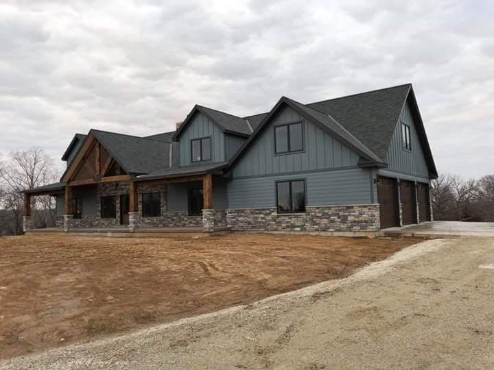 a large house sitting on top of a dry grass field