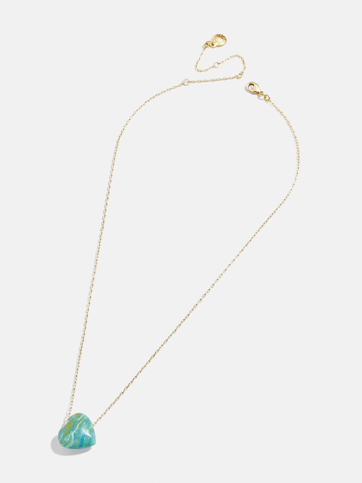 Opt for a little self love in your stack when you choose the Juno Necklace. This piece features a dainty gold chain complete with a heart-shaped pendant, made with natural turquoise stone. Turquoise represents and brings luck, peace, and protection, so this piece is sure to add good vibes to your necklace collection. Dainty Turquoise Pendant Necklace, Turquoise Jewelry With Delicate Chain For Gift, Turquoise Pendant With Delicate Chain, Turquoise Pendant Jewelry With Delicate Chain, Dainty Turquoise Necklace With Clavicle Chain, Dainty Turquoise Clavicle Chain Necklace, Turquoise Pendant Charm Necklace With Adjustable Chain, Adjustable Turquoise Jewelry With Delicate Chain, Dainty Turquoise Necklace With Adjustable Chain