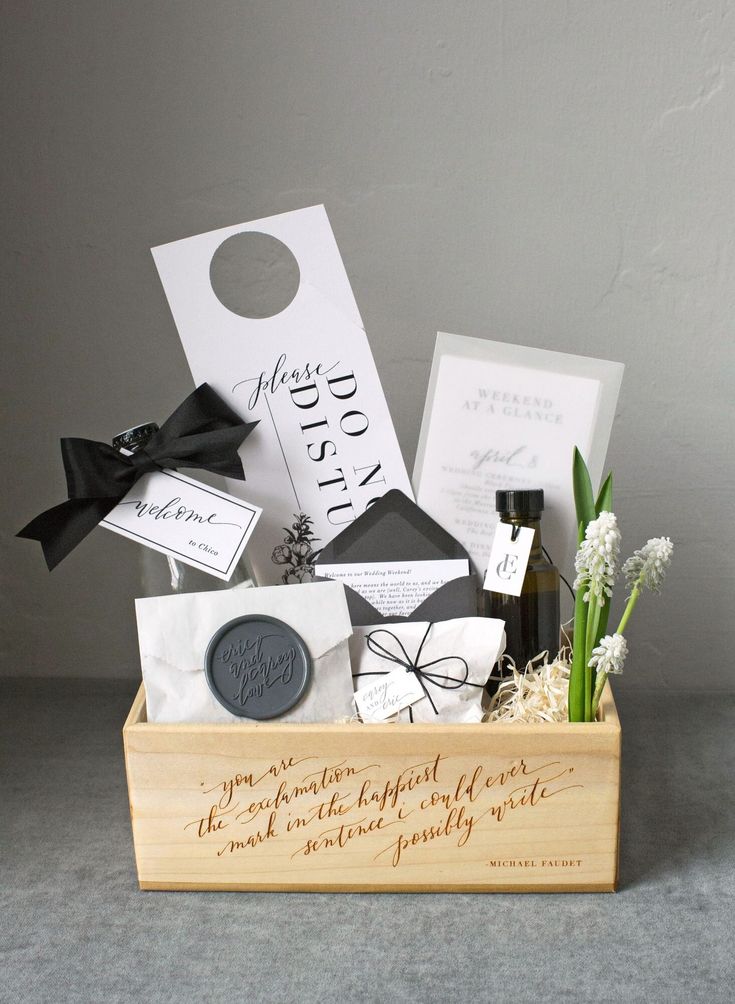 a wooden box filled with different types of wedding gift items and wine bottle in it