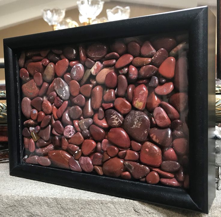 a black frame with red rocks in it