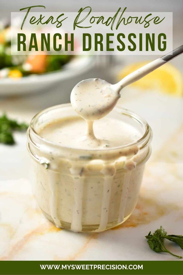 ranch dressing in a small glass jar with a spoon sticking out of it and the words, texas roadhouse ranch dressing