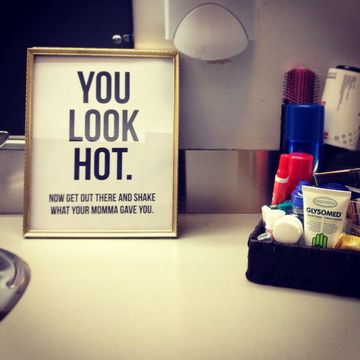 there is a sign that says you look hot next to some toiletries on the counter