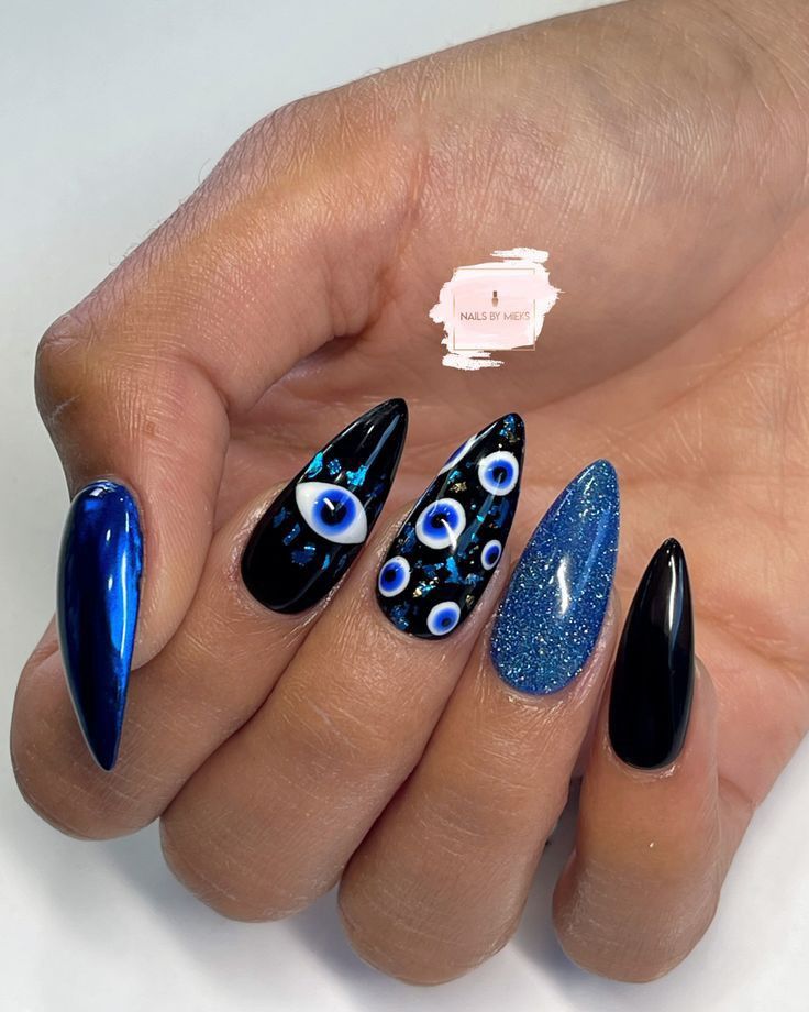 Blue And Black Halloween Nails, Hades Nails Art, Gen Z Nail Art, Evil Eye Nail Art Design, Black Evil Eye Nails, Hamsa Nails, Edgy Halloween Nails, Chrome Glitter Nails, Evil Eye Nails Design