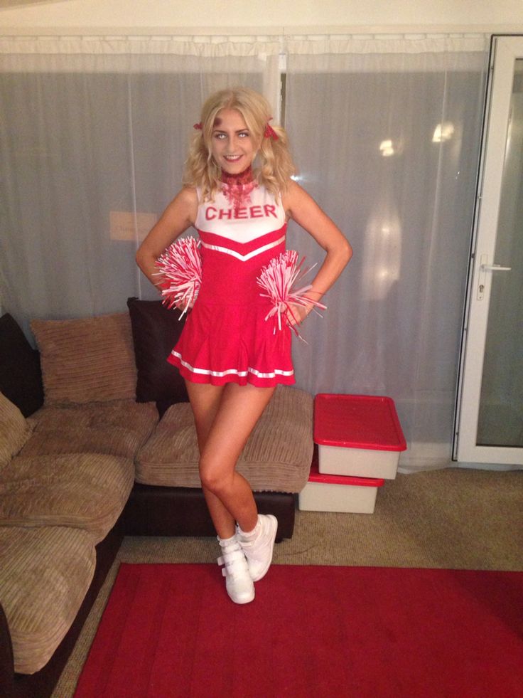 a woman in a cheerleader costume posing for the camera