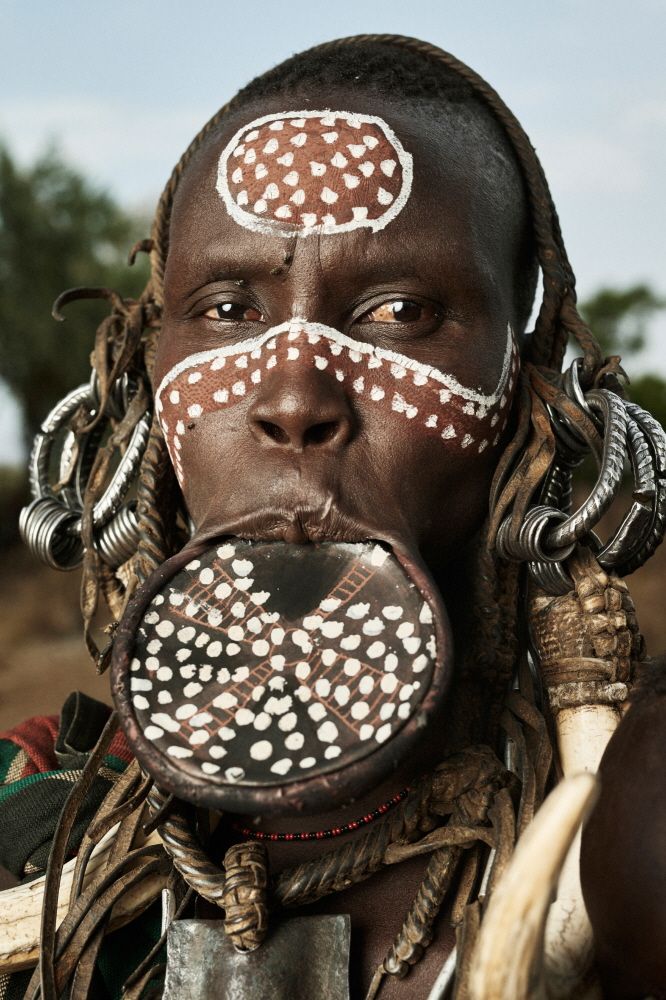 an african man with painted on his face and nose