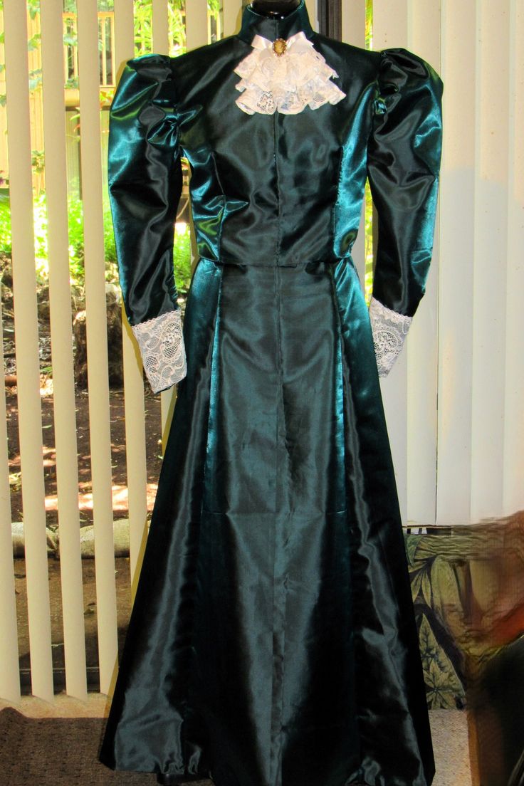 **YOU MUST TAKE YOUR MEASUREMENTS PRIOR TO CHOOSING A SIZE** This Edwardian/Victorian dress is actually a top and skirt, made in a beautiful bridal taffeta.  The photos display it in an emerald green color, but I am able to make it in any color you choose. The top is fully lined and lightly boned.  The puffed upper sleeves are stiffened with interfacing, and the lower sleeves are embellished with lace.  A lace-layered stay accompanied by a faux cameo pin at the neckband completes the look.  The top has hook and eye closures down the front of the bodice. The full length skirt is delicately pleated at the center back and also has hook and eye closures.  The hem is stitched by hand, and any exposed seams are overcast.  BODY MEASUREMENTS for Teens/Adults sizes are approximately: Size 6 - Chest Elegant Fitted Long Sleeve Costumes, Elegant Long Sleeve Fitted Costume, Fitted Victorian Floor-length Dress For Costume Parties, Fitted Floor-length Victorian Dress For Costume Party, Fitted Floor-length Victorian Costume Dress, Elegant Fitted Dresses For Cosplay Events, Fitted Ball Gown For Cosplay, Regency Style Fitted Wedding Costumes, Fitted Long Sleeve Medieval Dress For Cosplay