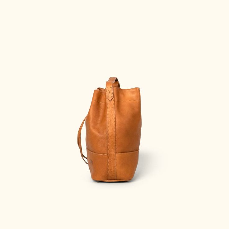 *Expected to be restocked and available to ship 7/9/21* First, design a trendy leather bucket bag that doesn’t look like a bucket. Next, offer it in full leather or canvas/leather options. Then, provide a comfortable leather strap so it can be worn cross-body or over the shoulder. And finally, thread it with a smooth leather drawstring to close it all up. The result? The Madison Leather Bucket Bag. Actually, there are a couple more features. An interior zipper pocket for things you want to keep Buffalo Jackson, Dark Brown Leather Jacket, Everyday Purse, Leather Duffle Bag, Lambskin Leather Jacket, Leather Duffle, The Madison, Leather Handbags Women, Striped Fabric