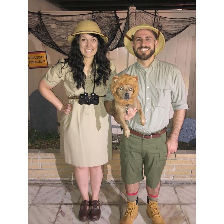 the man and woman are posing for a photo with their dog in cowboy hats on