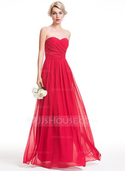 a woman in a strapless navy blue bridesmaid dress holding a white bouquet