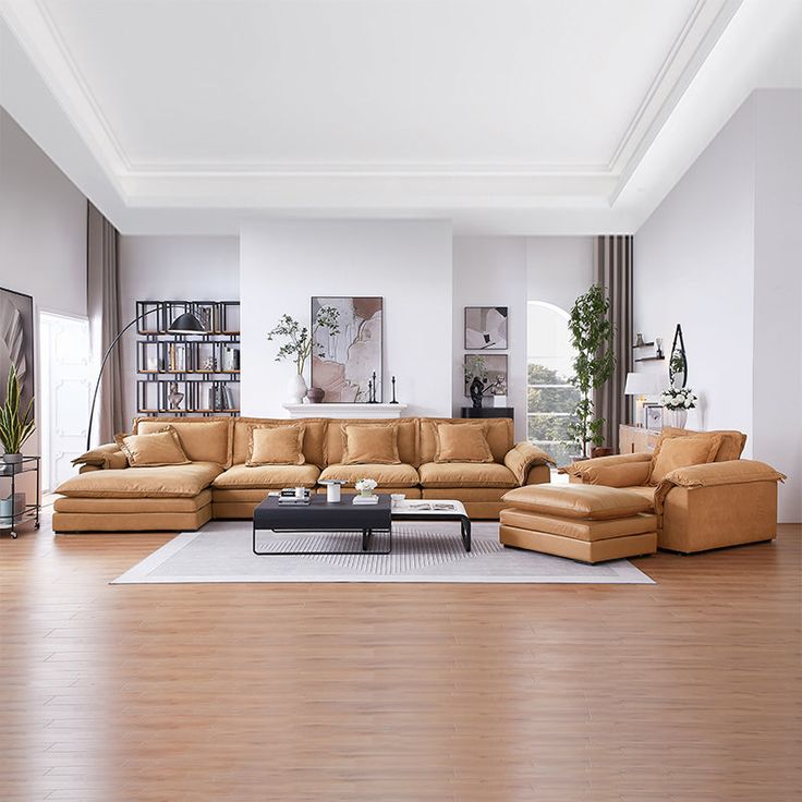 a living room filled with lots of furniture and a white rug on top of a hard wood floor