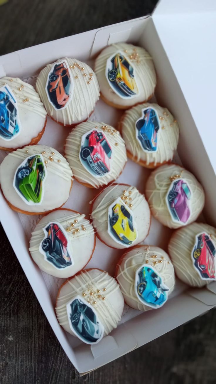 a box filled with cupcakes covered in frosting and decorated like disney characters