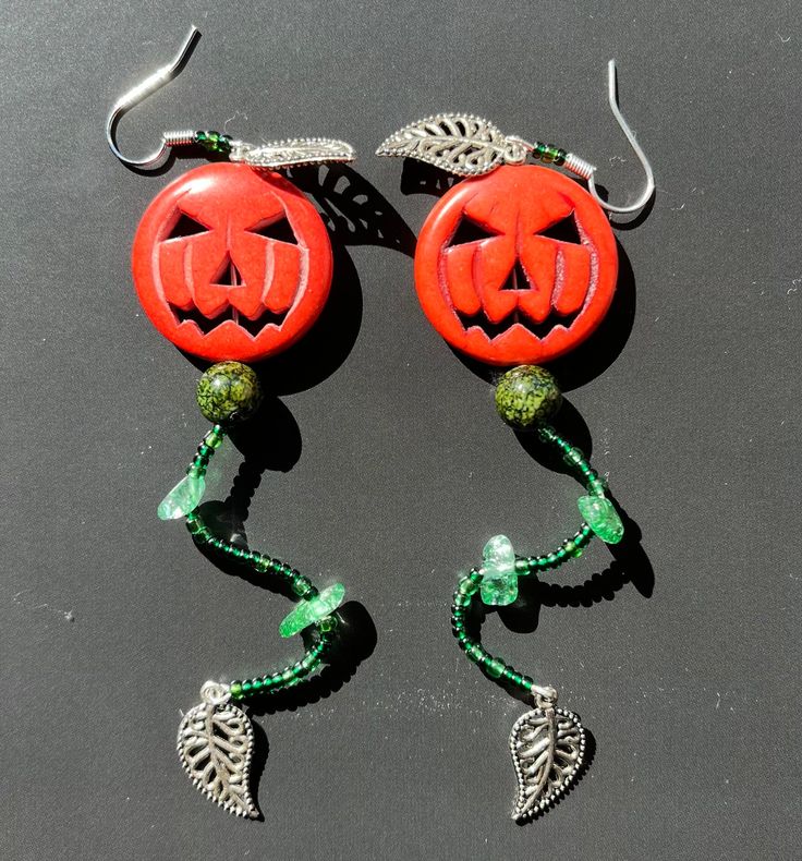 "These \"Straight From the Vine\" earrings are handmade from both bought and found materials. They are perfect for the autumnal/Halloween season (or year round if you enjoy wearing spooky jewelry any time)! I hope you consider buying, and if you do, I hope you love them! Dimensions and weight: 4 inches long, 1 inch wide, lightweight (0.2 oz/7 g). Standard shipping and returns." Spooky Handmade Earrings For Halloween, Red Pierced Halloween Earrings, Handmade Spooky Halloween Earrings, Handmade Witchy Earrings For Halloween, Spooky Handmade Halloween Earrings, Handmade Halloween Earrings Gift, Red Pierced Earrings For Halloween, Green Novelty Earrings For Halloween, Halloween Plug Earrings As Gift