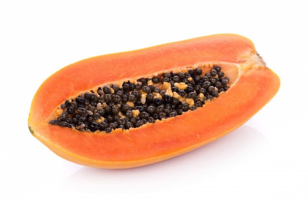 a papaya cut in half with seeds on it's side and one piece missing