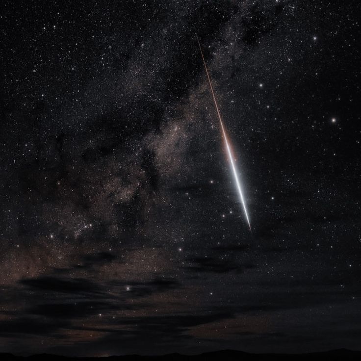 an object is seen in the sky with stars and clouds behind it, as well as a shooting star