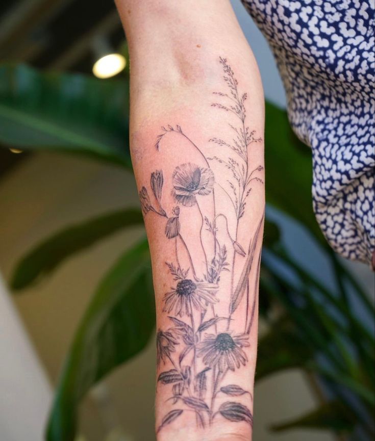 a person with a flower tattoo on their arm