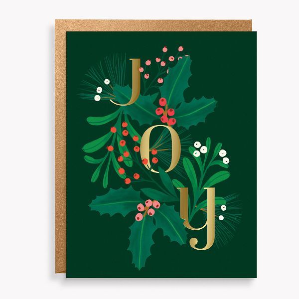 a christmas card with the word joy on it and holly branches in gold foil lettering