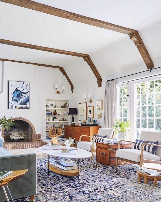 a living room filled with furniture and a fire place in the middle of a room