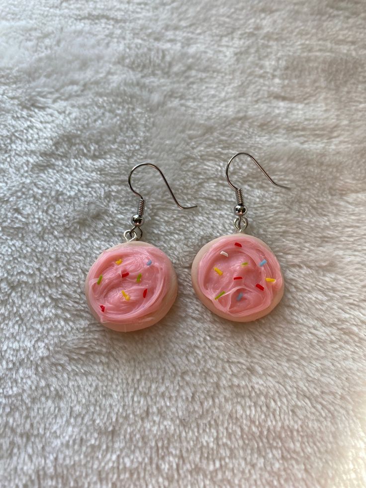 These are adorable sugar cookie earrings with pink frosting and sprinkles, fully made with polymer clay. The eye pin is extra secure by using liquid clay to ensure the earring will stay together. Pink Polymer Clay Birthday Earrings, Pink Polymer Clay Earrings For Birthday, Pink Polymer Clay Birthday Jewelry, Playful Pink Round Earrings, Sweet Pink Nickel-free Earrings, Nickel-free Sweet Pink Earrings, Sweet Pink Polymer Clay Jewelry, Pink Resin Novelty Earrings, Fun Pink Polymer Clay Earrings