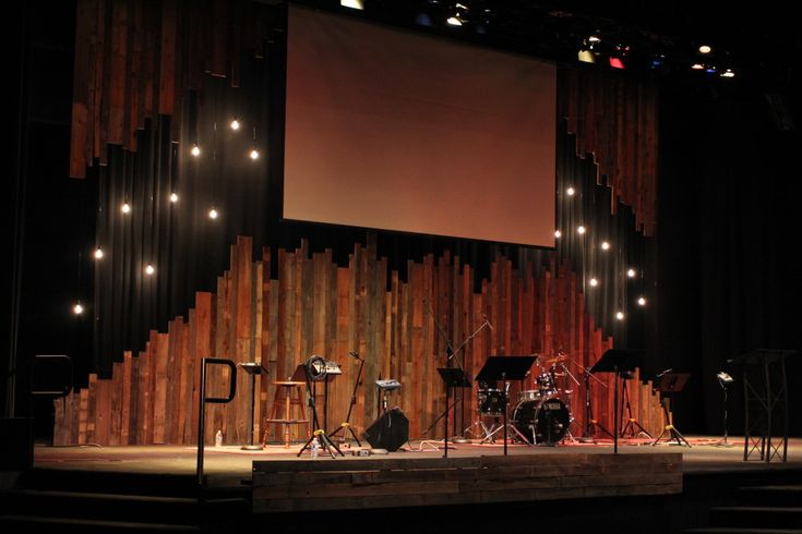 an empty stage with musical instruments on it