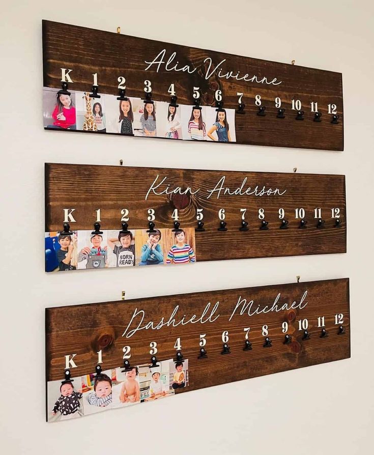 three wooden signs hanging on the wall with family photos and date names attached to them