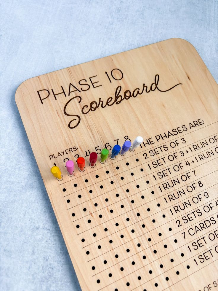 a wooden board with pins and numbers on it for the game of scrabble