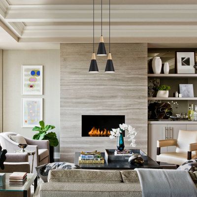 a living room filled with furniture and a fire place in the middle of the room