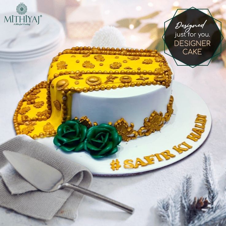 there is a cake that has been decorated with gold and green decorations on it,