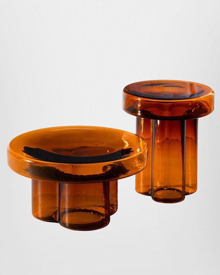 two brown glass vases sitting next to each other