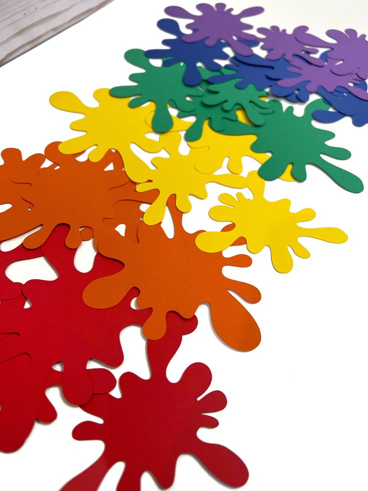 colorful paper cut outs sitting on top of a table