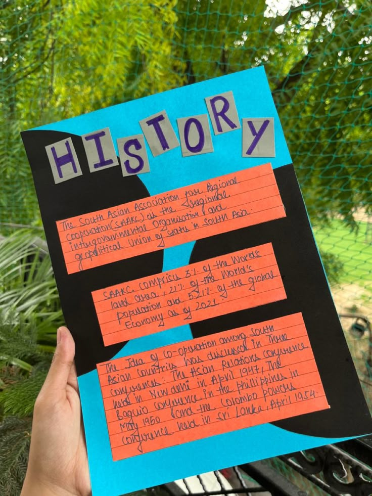 a person holding up a piece of paper with writing on it and the words history