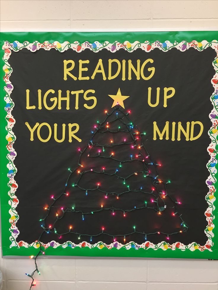 a bulletin board with lights on it that says reading lights up your mind and a christmas tree