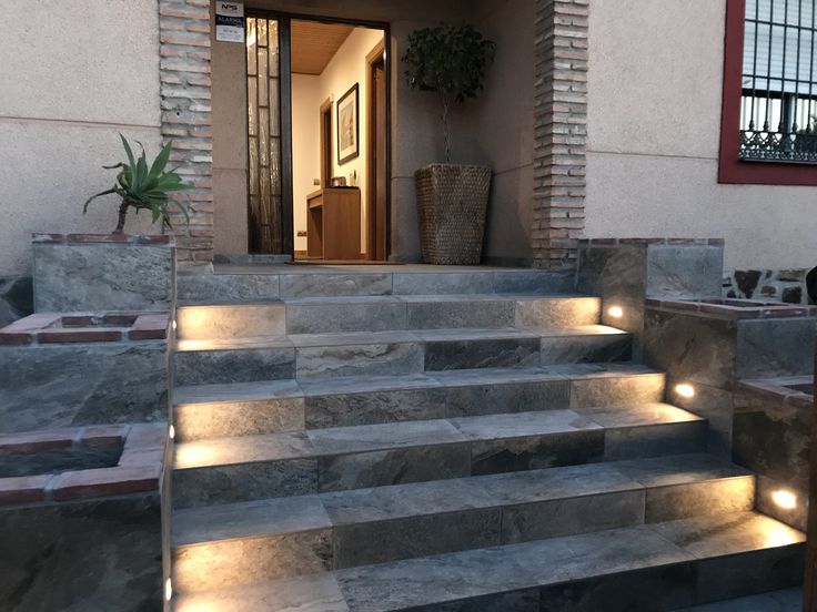 some steps lit up with lights in front of a house