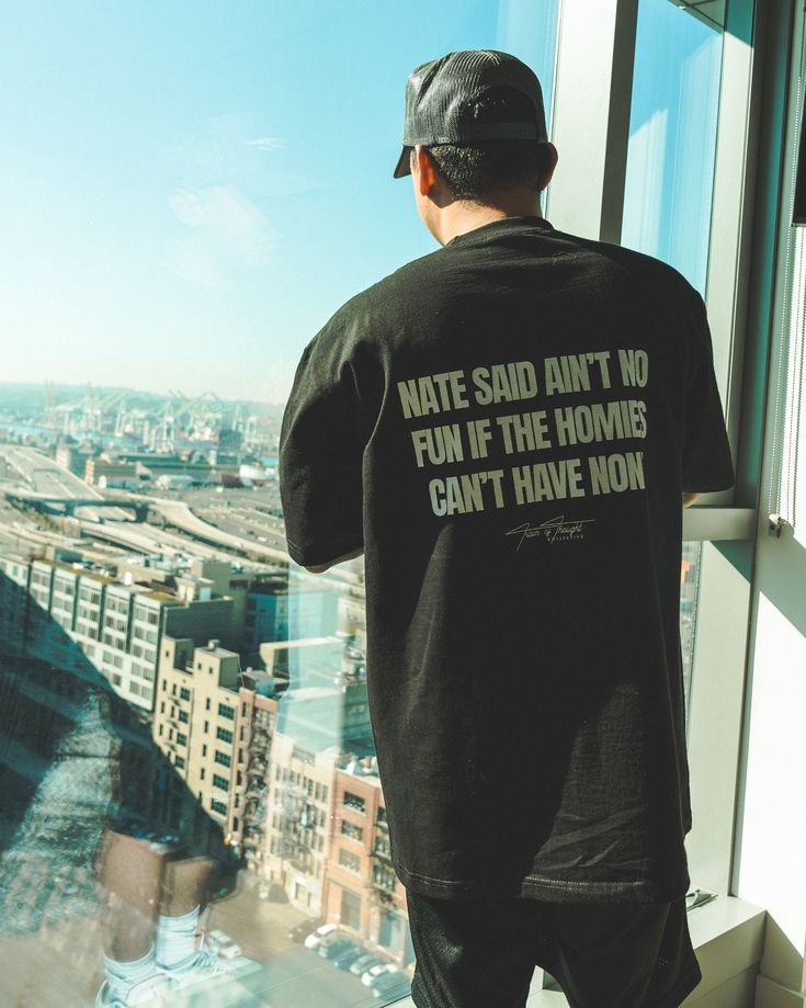 a man standing on top of a tall building looking out at the cityscape