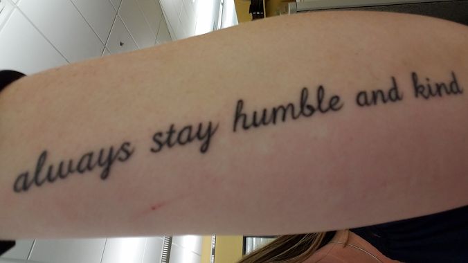 a person with a tattoo on their arm that says, always stay humble and kind