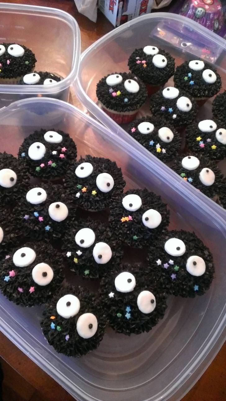 cupcakes decorated with eyes and sprinkles in plastic containers