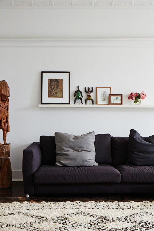 a living room filled with furniture and pictures on the wall