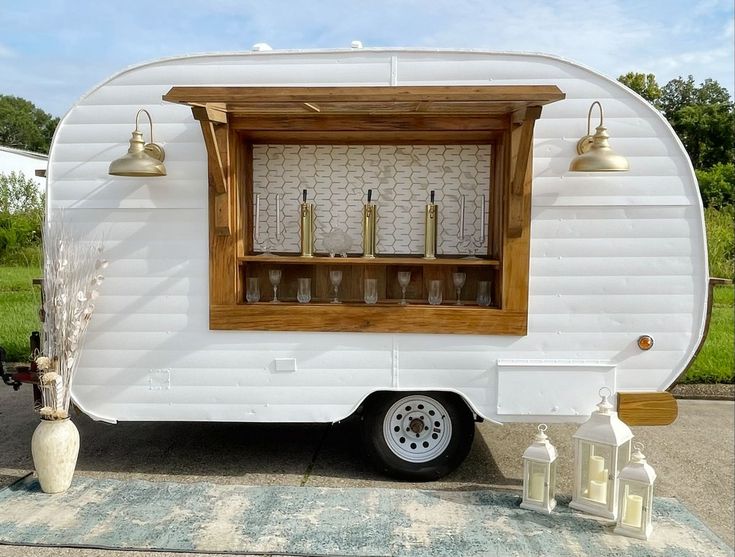 a small white trailer parked on top of a parking lot