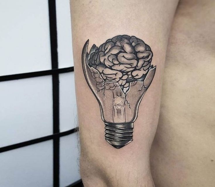 a man's arm with a light bulb and brain tattoo on the left side