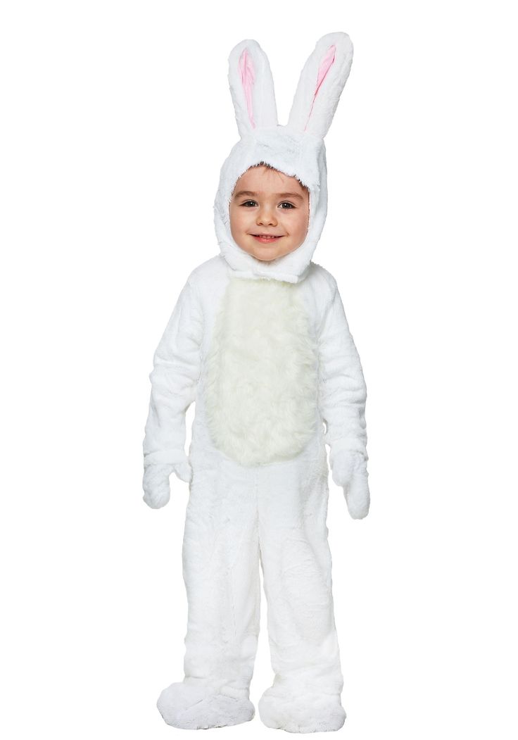 a little boy wearing a white bunny costume