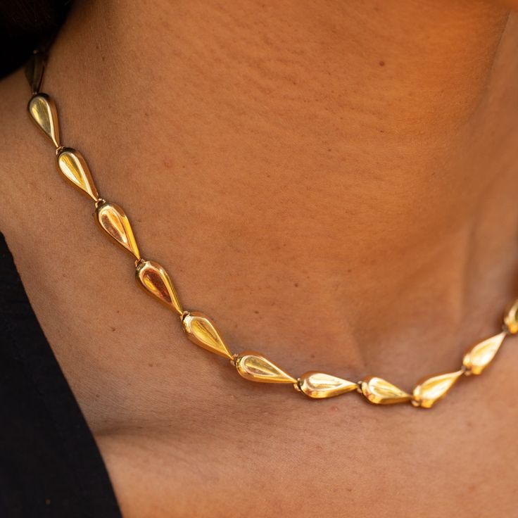 The Story This chic gold chain necklace is the ultimate jewelry staple. Made from rich 18 karat yellow gold, the necklace measures 15.5 inches and sits at the collar bone. Comprised of 25 tear-dropped shaped links, the length is perfect for a shorter, choker look. Made by Birks, an heirloom Canadian brand founded in 1879, the construction is lovely. Each of the links is semi-hollow, so while the necklace has a lovely presence, it's not too heavy. It looks great on its own or worn layered with ot Formal Teardrop Chain Necklace With Adjustable Chain, Formal Teardrop Chain Necklace, Elegant Gold Chain Necklace With Teardrop, Luxury Gold Briolette Drop Necklace, Gold Drop Necklace For Formal Occasions, Elegant Teardrop Gold Chain Necklace, Elegant Teardrop Necklace With Gold Chain, Timeless Gold Drop Necklace For Formal Occasions, Formal Teardrop Necklace With Chain