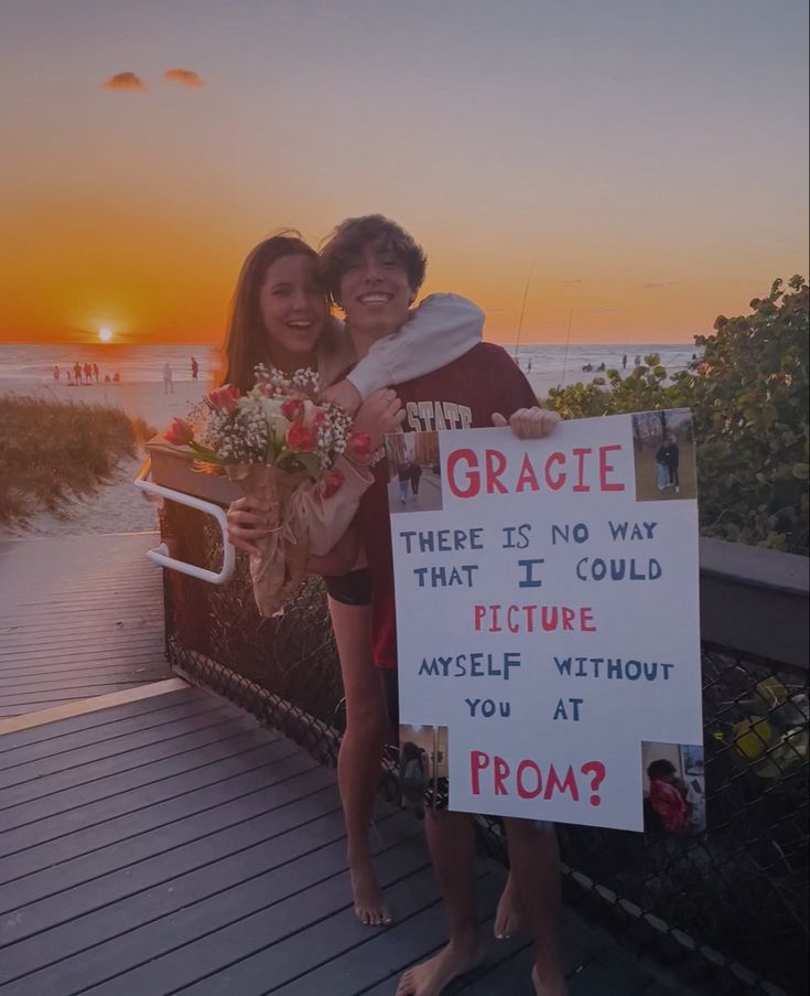 two people standing next to each other holding flowers and a sign that says gracie there is no way that i could picture yourself without my self without you at sunset