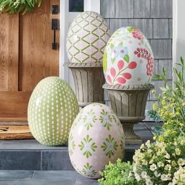 three decorated eggs sitting on the front steps