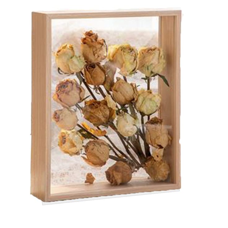 a wooden frame with flowers in it on a white background and the image is framed