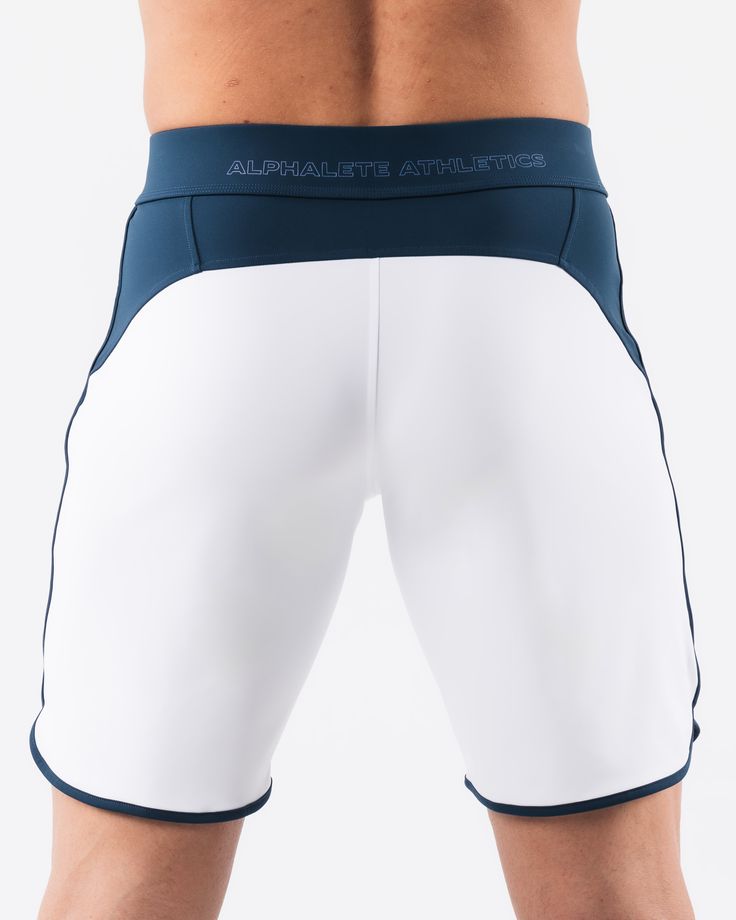 HIGHLIGHTS.. Unlined boardshort. 9” inseam Reflective branding at leg opening and back waistband Elastic waistband with adjustable self-tie drawcords Color-blocking panelling Water resistant fabric FIT SUGGESTION. This item runs true to Alphalete’s standard sizing.. Fit is based off of waist size in inches.. If you are between sizes, we recommend sizing up for a relaxed fit.. Eric is 6’2”/188cm, wearing a size 32. MATERIALS AND WASHING DIRECTIONS. 67% Nylon, 23% spandex. Due to the high saturati White Nylon Athletic Shorts With Built-in Shorts, Training Shorts With Elastic Side Panels, White Training Bottoms With Elastic Side Panels, Sporty Nylon Shorts With Contoured Waistband, White Swim Trunks With Built-in Shorts, White Activewear With Elastic Side Panels For Gym, White Activewear For Gym With Elastic Side Panels, White Gym Activewear With Elastic Side Panels, White Activewear With Contoured Waistband For Sports