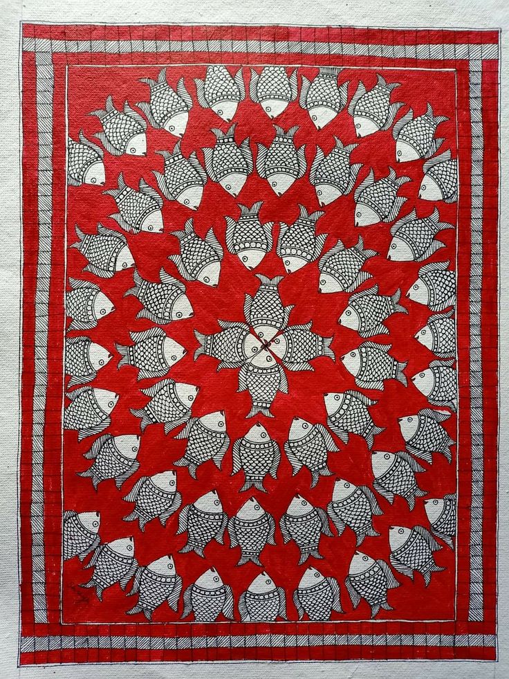 a red and white quilt with fish on it's sides, in the center