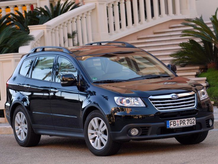 a black subarunt is parked in front of some steps