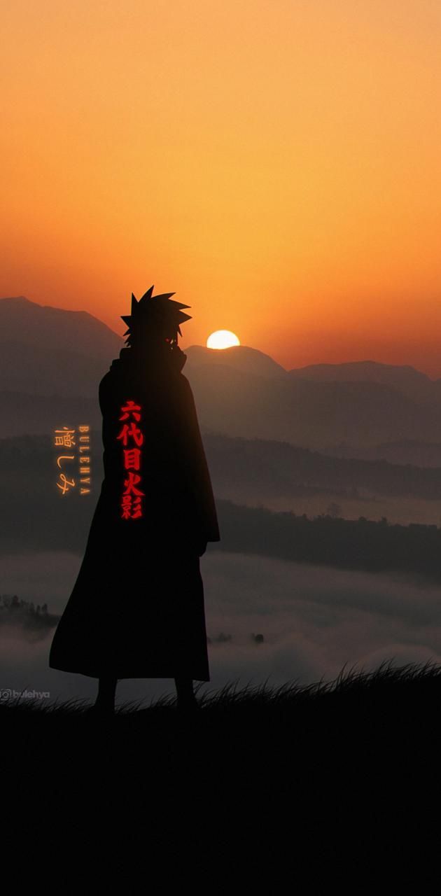 the silhouette of a person standing on top of a hill in front of a sunset