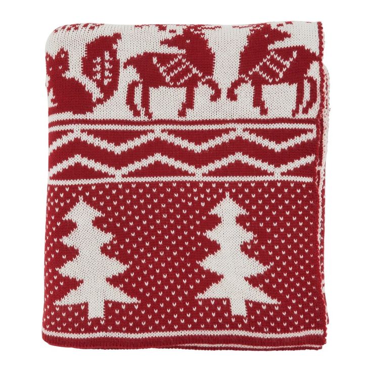 a red and white knitted christmas stocking with trees, elephants and snowflakes