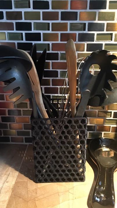 there are many different types of kitchen utensils in this basket on the counter